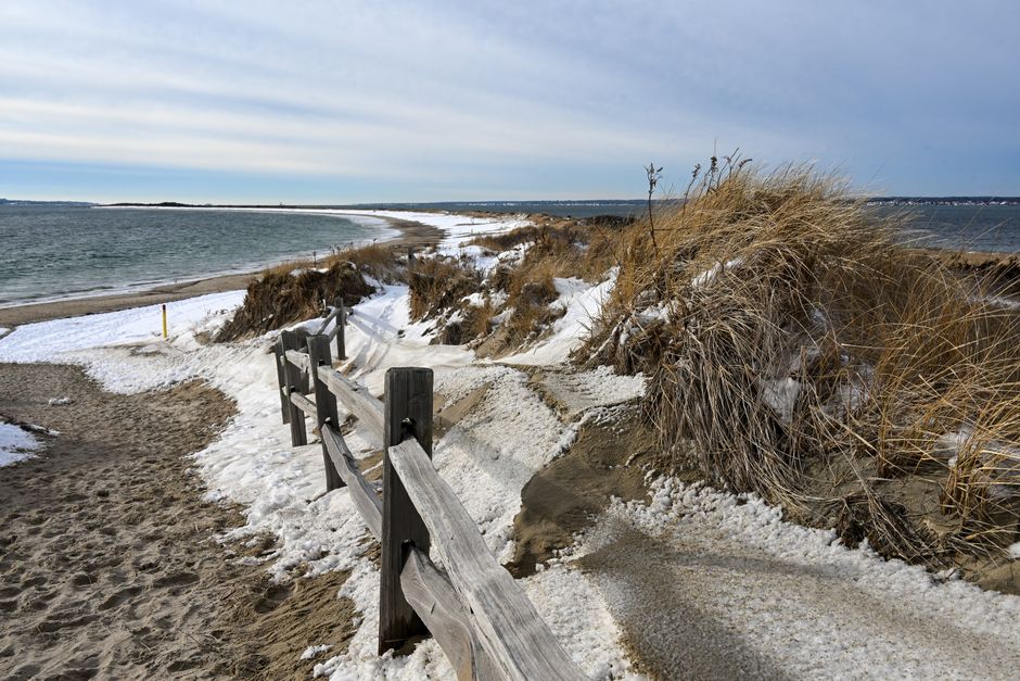 Scenic winter landscape at a snowy beach in Westerly, Rhode Island, with ocean view.