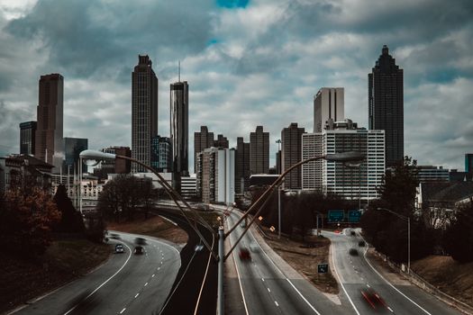 Dramatic view of Atlanta skyline with overcast clouds and urban streets.
