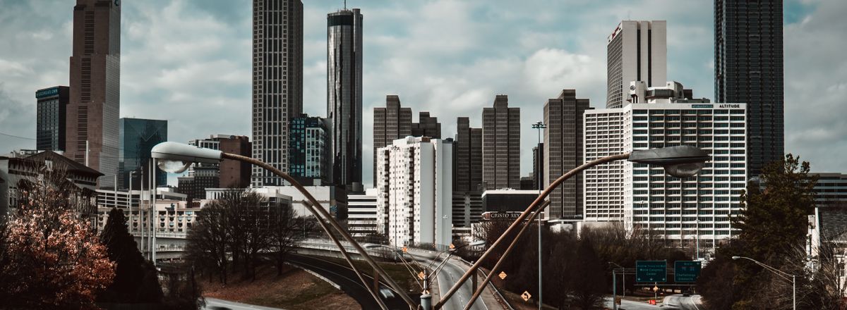 Stunning view of Atlanta skyline from Jackson Street Bridge on a cloudy day.