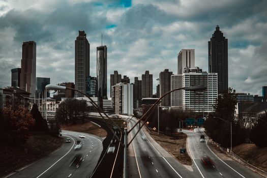 View of the Atlanta skyline on a cloudy day with highways in the foreground.