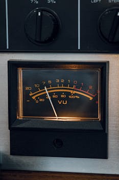 Detailed view of a vintage VU meter on classic audio equipment, retro style.