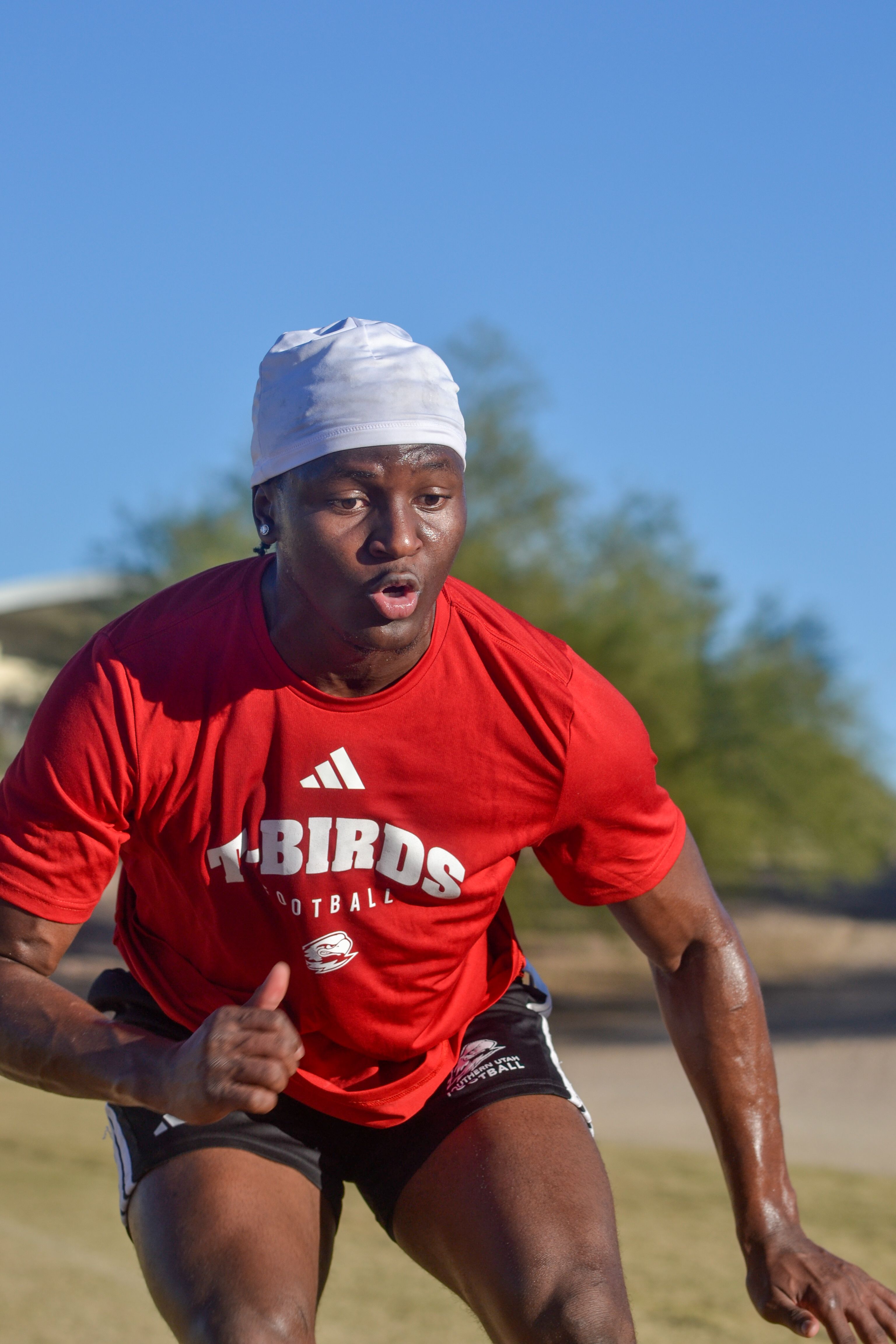 Young athlete in intense outdoor fitness training session in Scottsdale, Arizona, under clear sky.