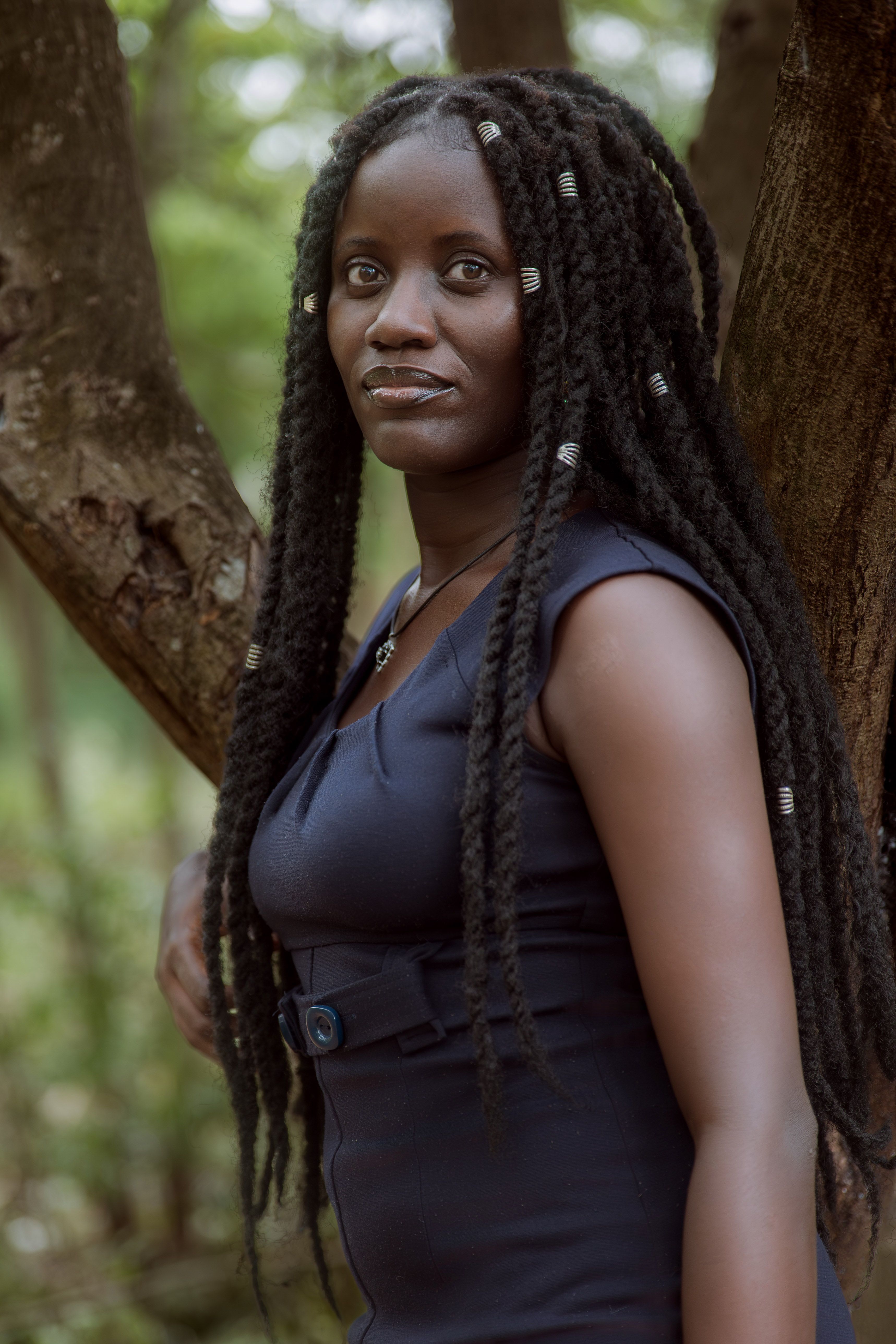 Elegant Woman Posing by a Tree in Nature · Free Stock Photo