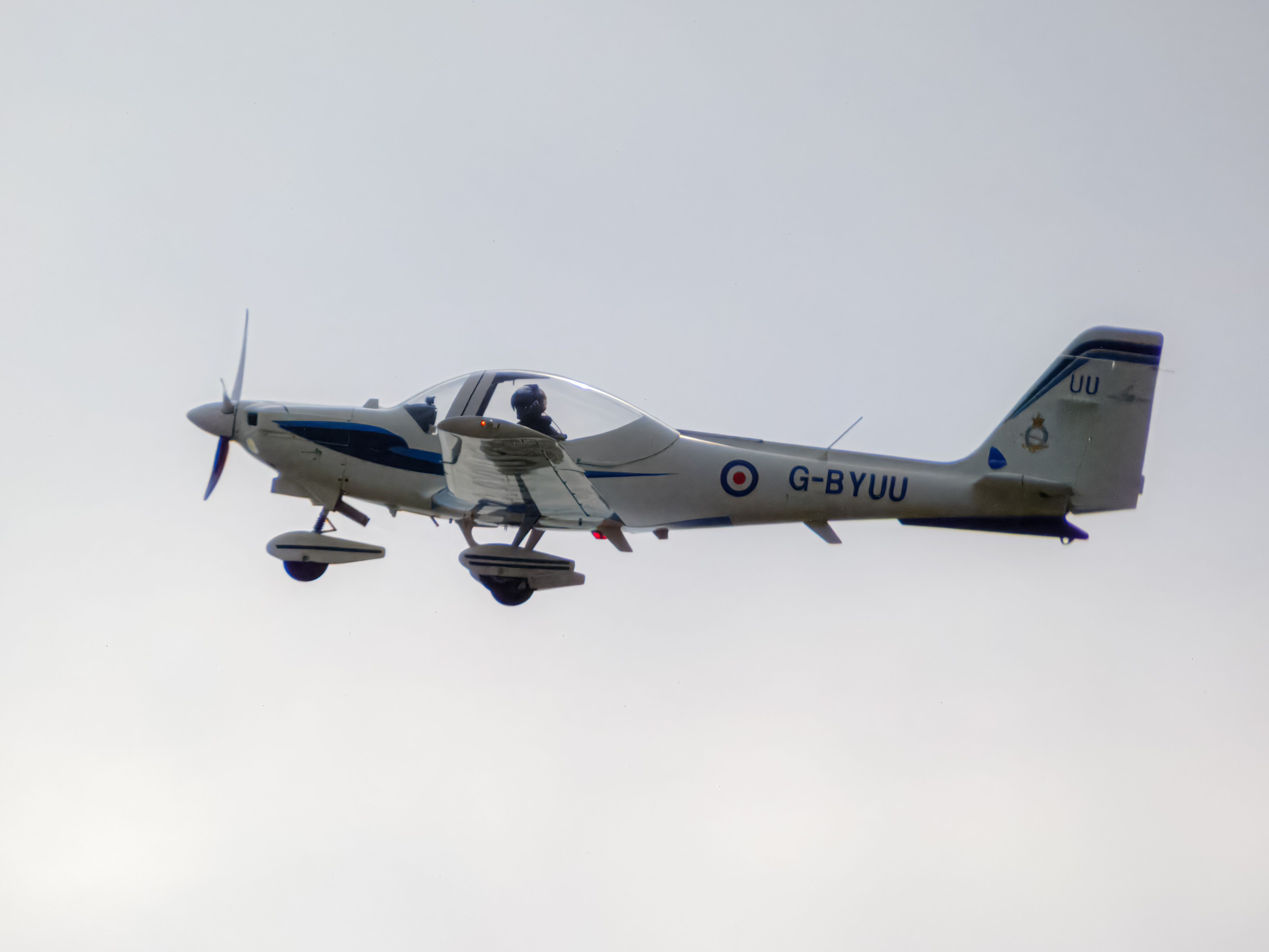 A light aircraft flying in a clear sky, showcasing aviation technology and design.