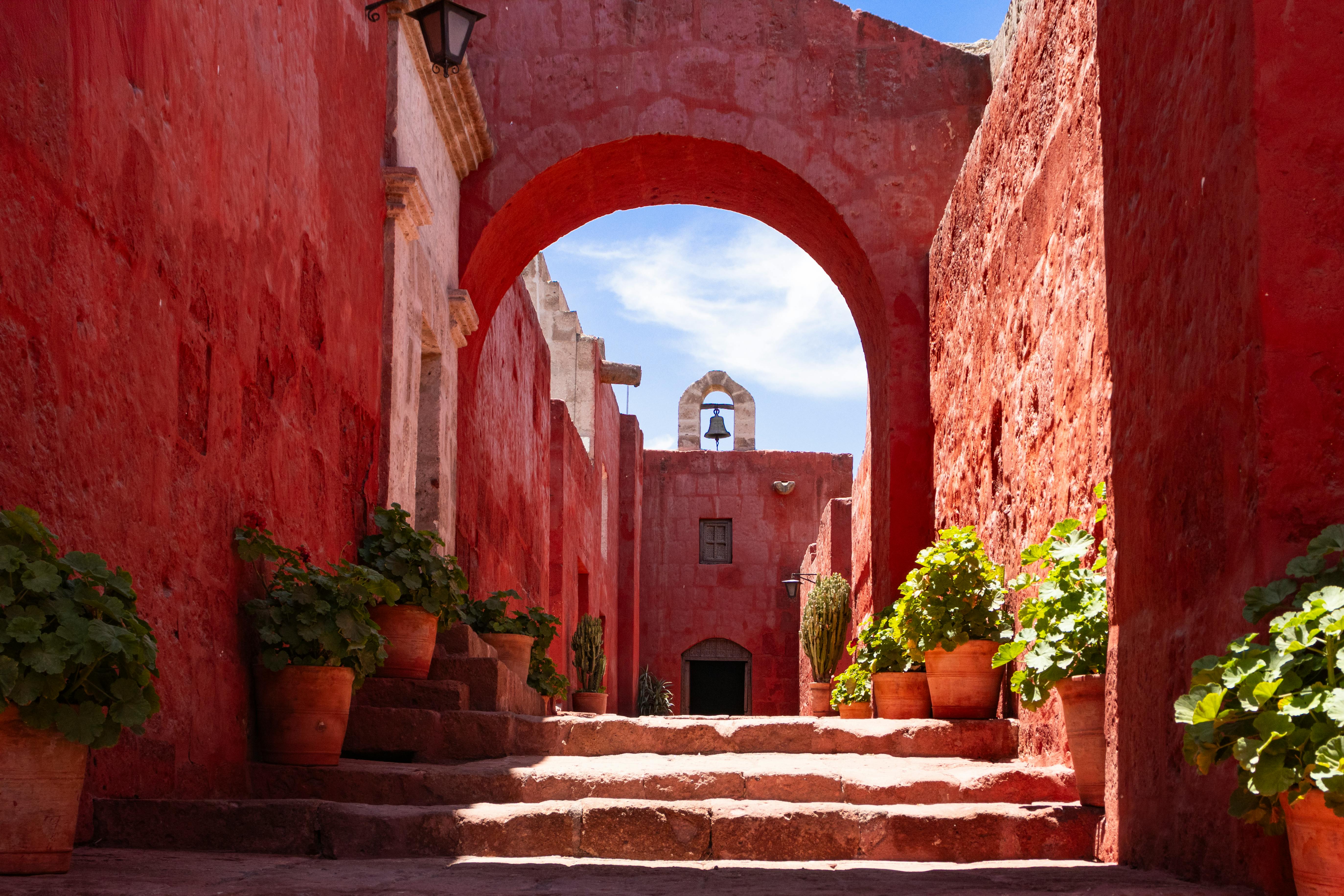 Explore the vibrant red walls of Santa Catalina Monastery in Arequipa, Peru, showcasing colonial architecture. - Arequipa