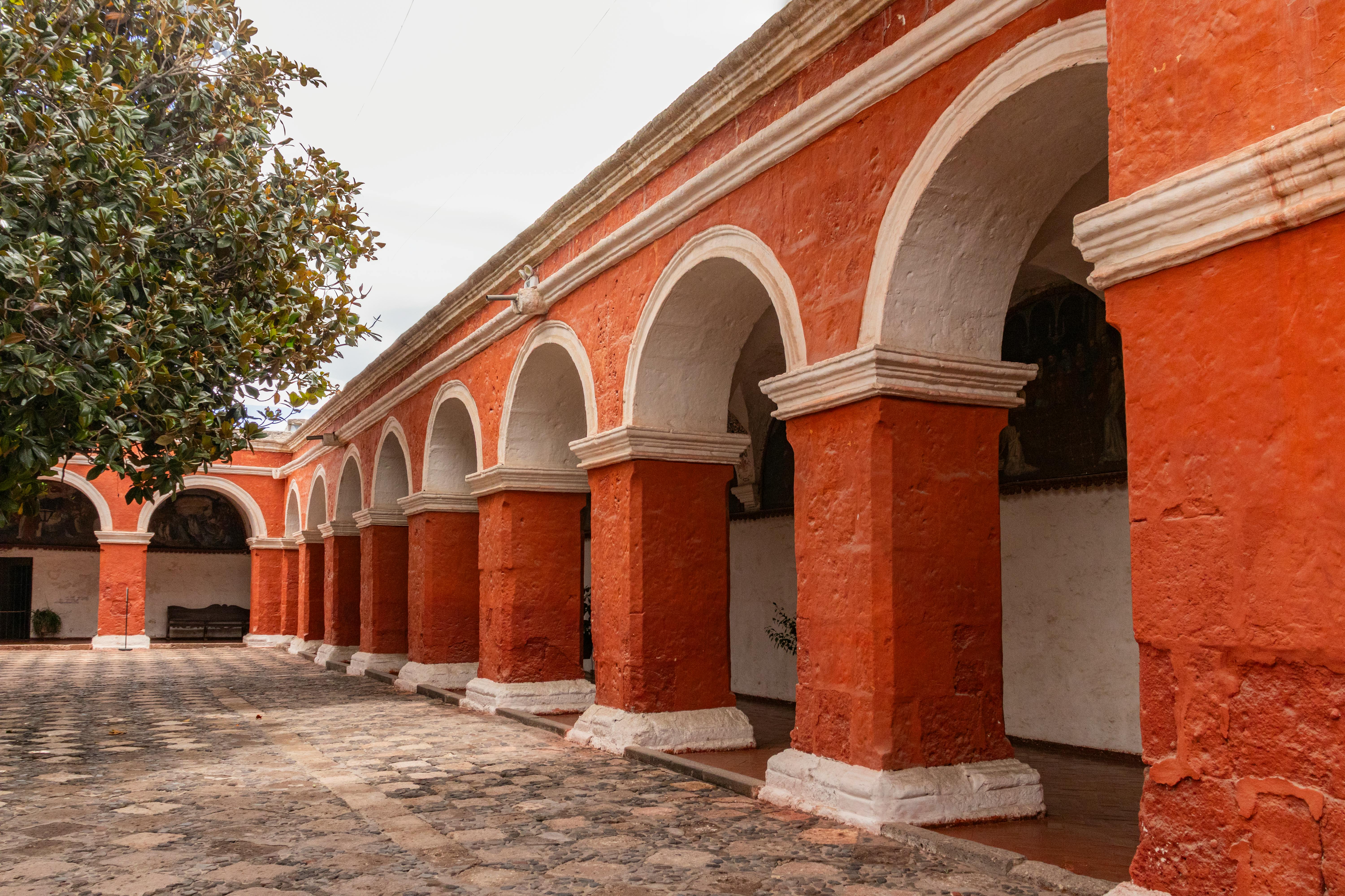 Explore the iconic red-walled cloister of Santa Catalina Monastery in Arequipa, Peru, showcasing colonial architecture.