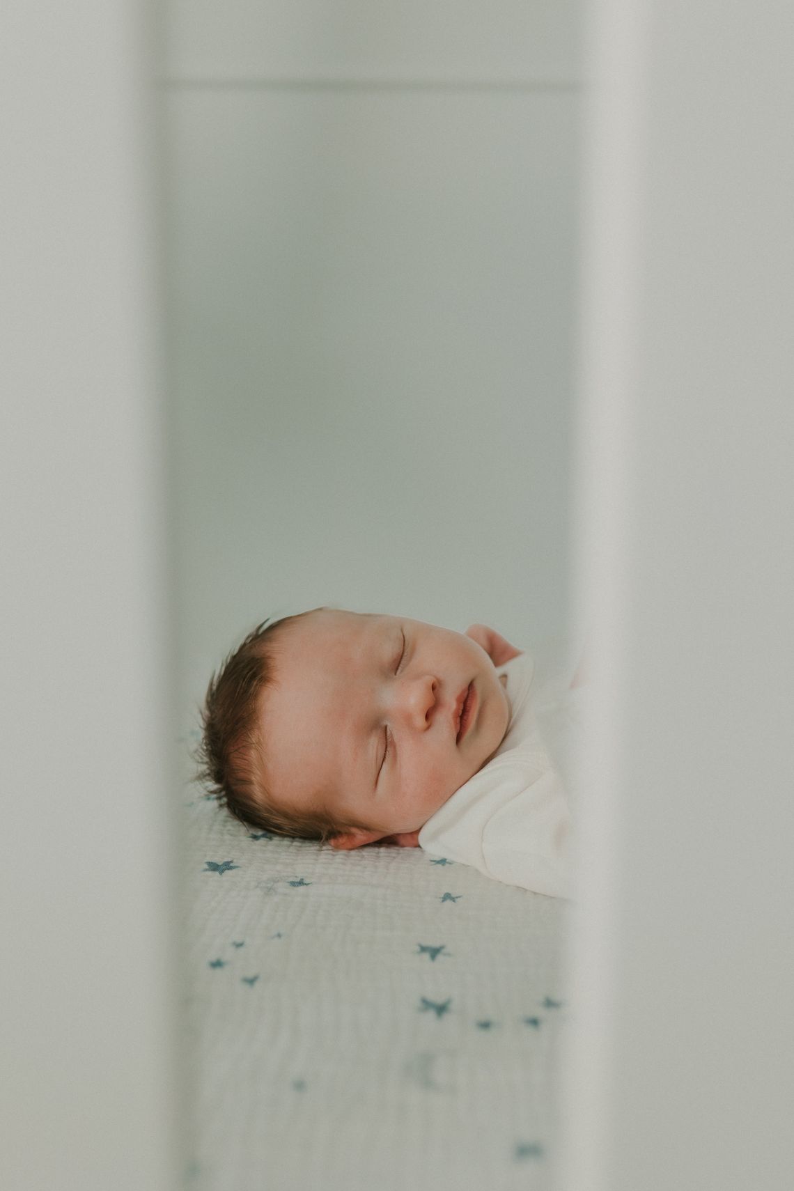 A newborn sleeping peacefully in a crib