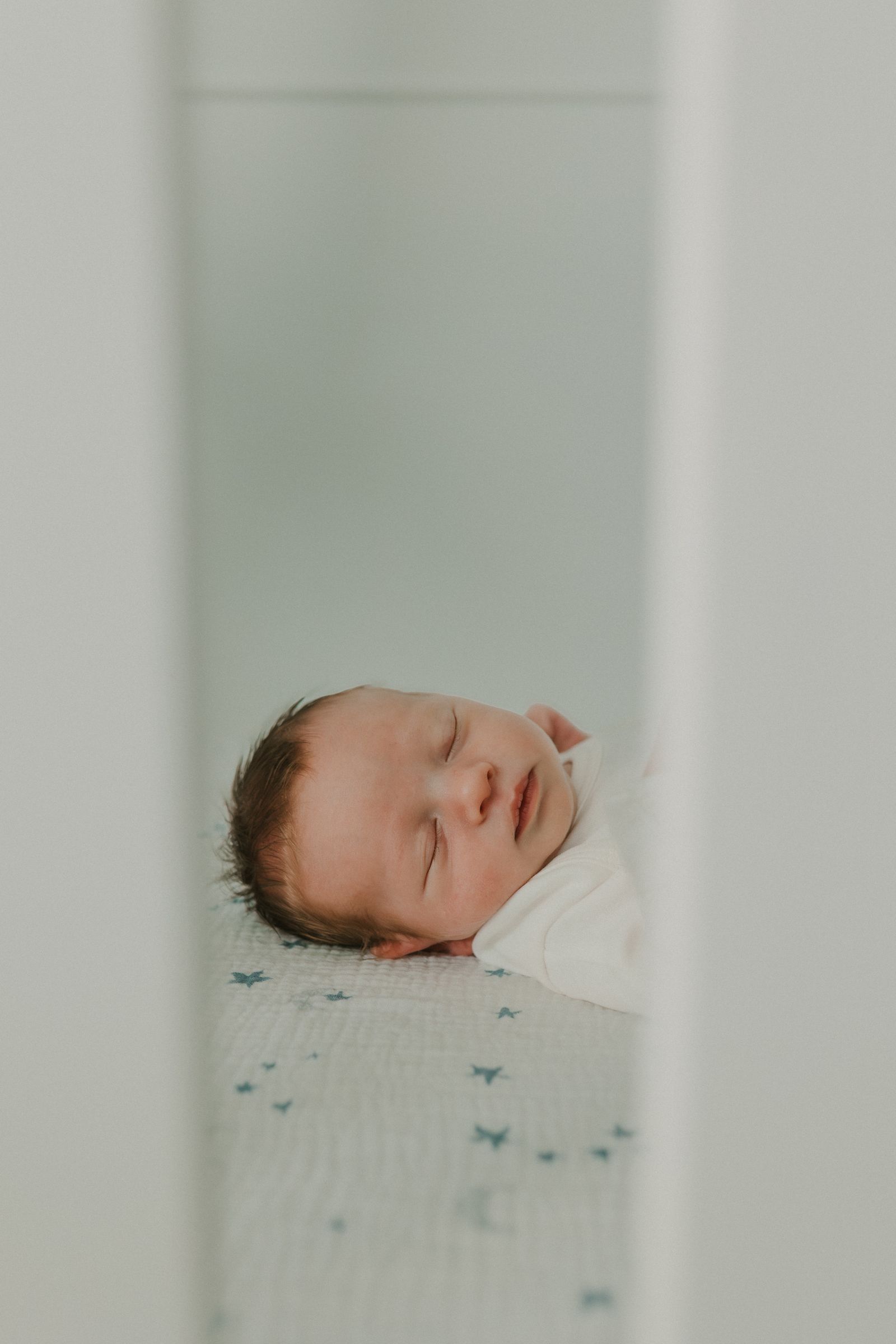 Newborn baby sleeping peacefully in a crib