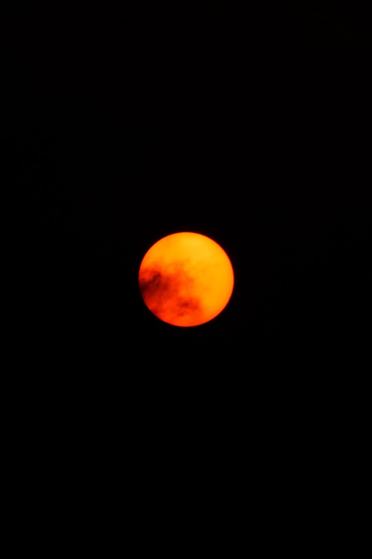 Orange Moon In Dark Night Sky