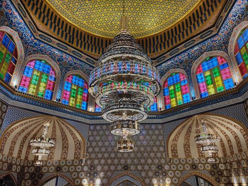 Free Beautiful mosque interior featuring ornate chandeliers and vibrant stained glass windows. Stock Photo