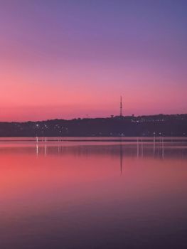 Beautiful sunrise over Bhopal Lake, India, showcasing vibrant colors and serene reflections.