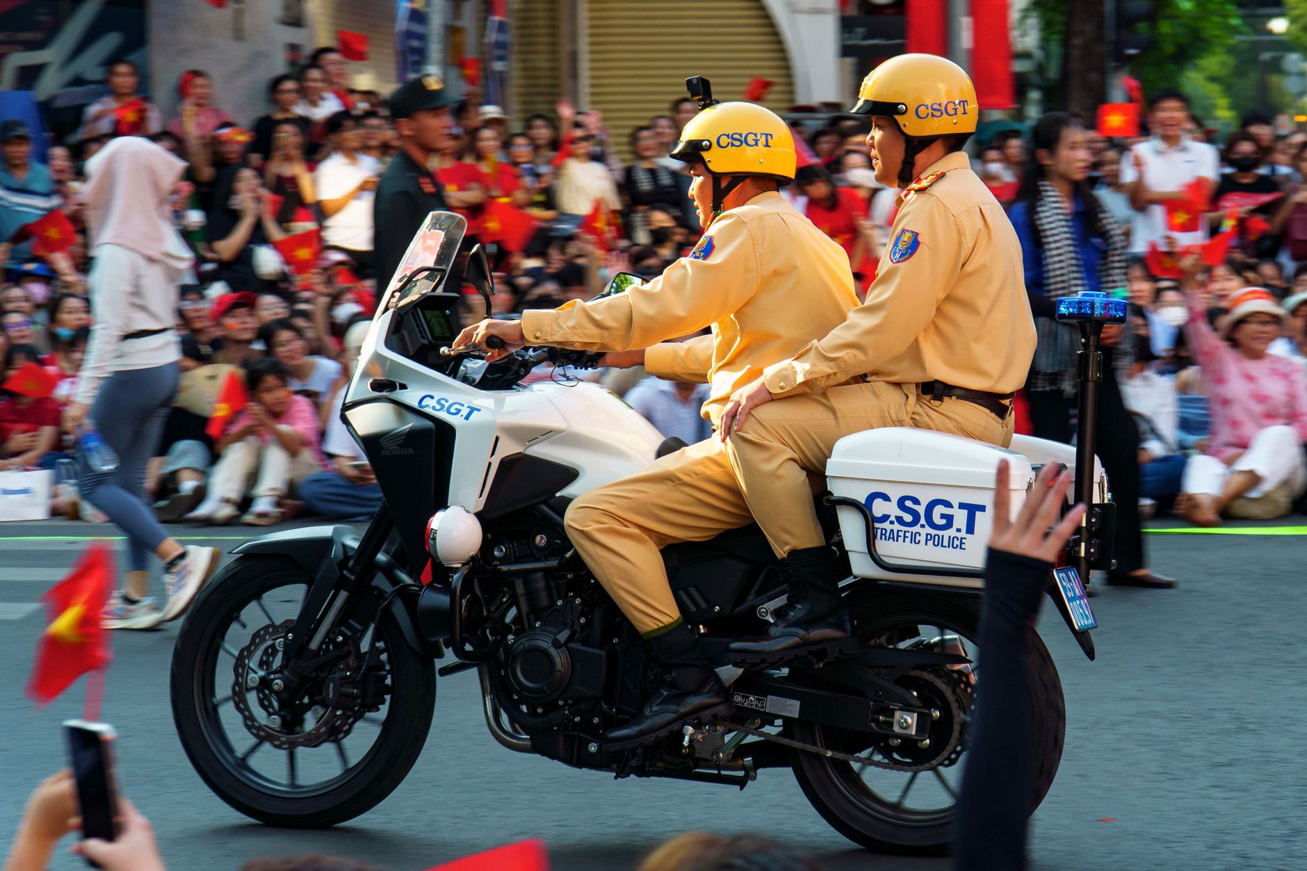 Vietnamese police examining seized betting slips and mobile phones at an illegal cockfighting venue