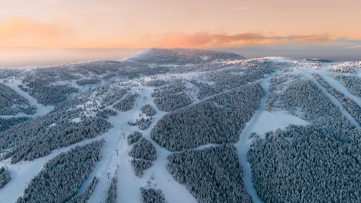 Aerial View of Snowy Mountain Ski Resort at Sunrise · Free Stock Photo