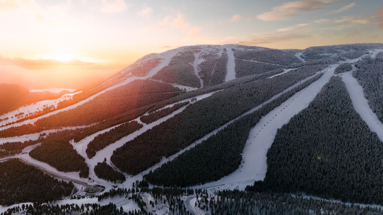 Aerial View of Snowy Mountain Ski Resort at Sunrise · Free Stock Photo