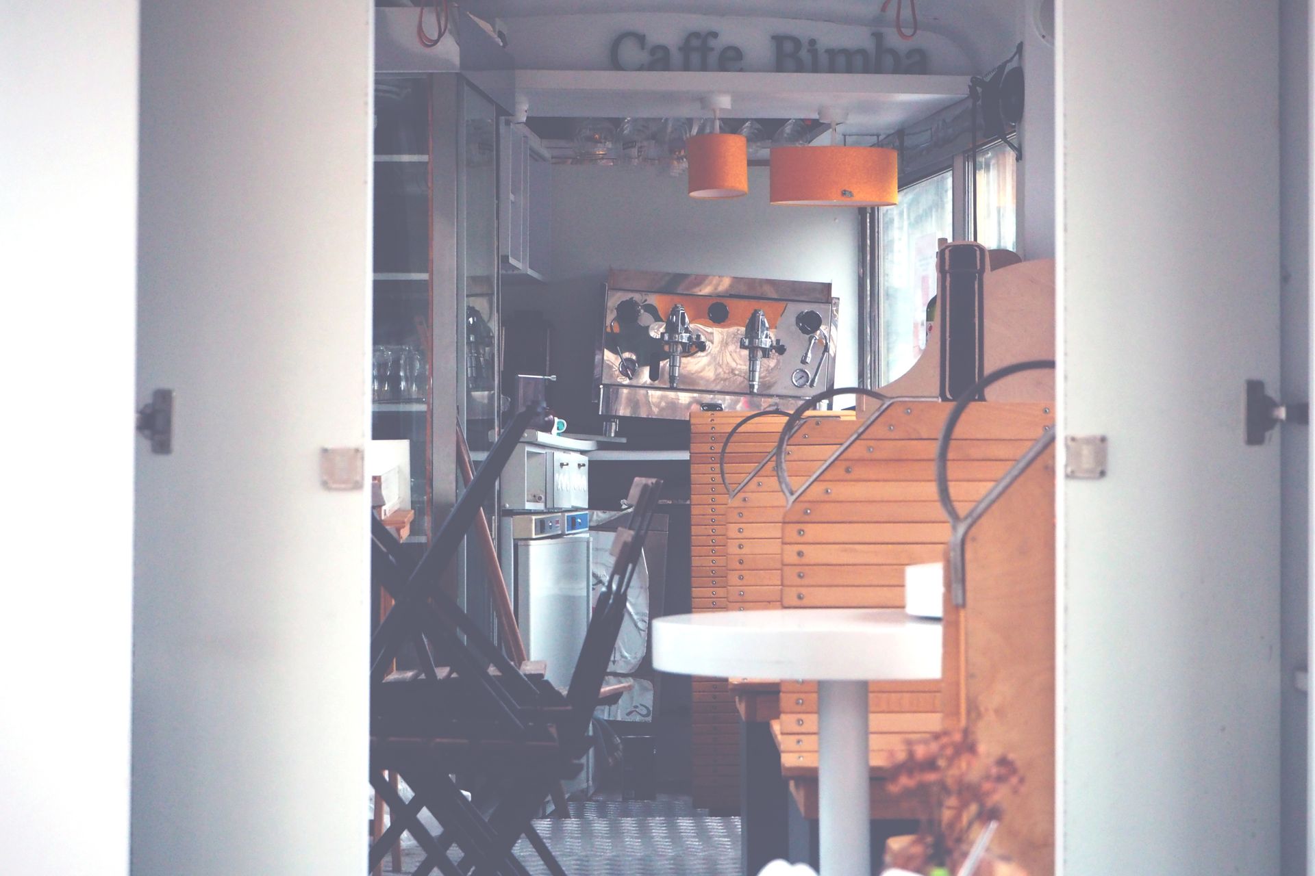 Warm and inviting interior of Caffe Bimba featuring wood furniture and soft lighting.