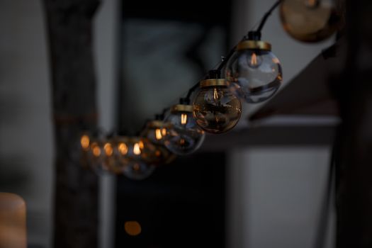 Close-up of glowing string lights creating a warm ambiance in a night setting.