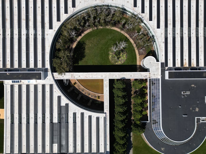 High-angle shot of a modern building with green roof and geometric design.
