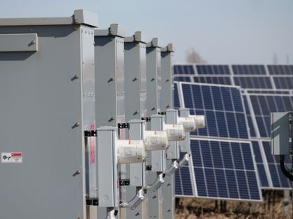 Storage cabinets beside a solar array, photo by Giant Asparagus on Pexels