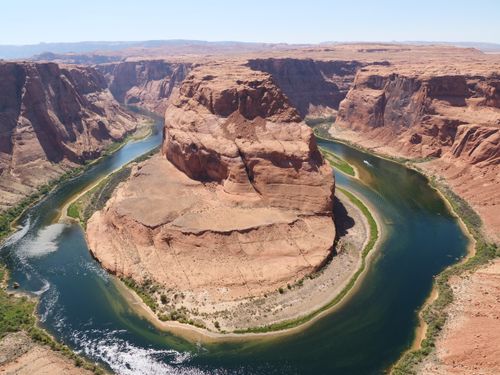 Free Stunning aerial shot of Horseshoe Bend with the Colorado River winding through the desert landscape. Stock Photo