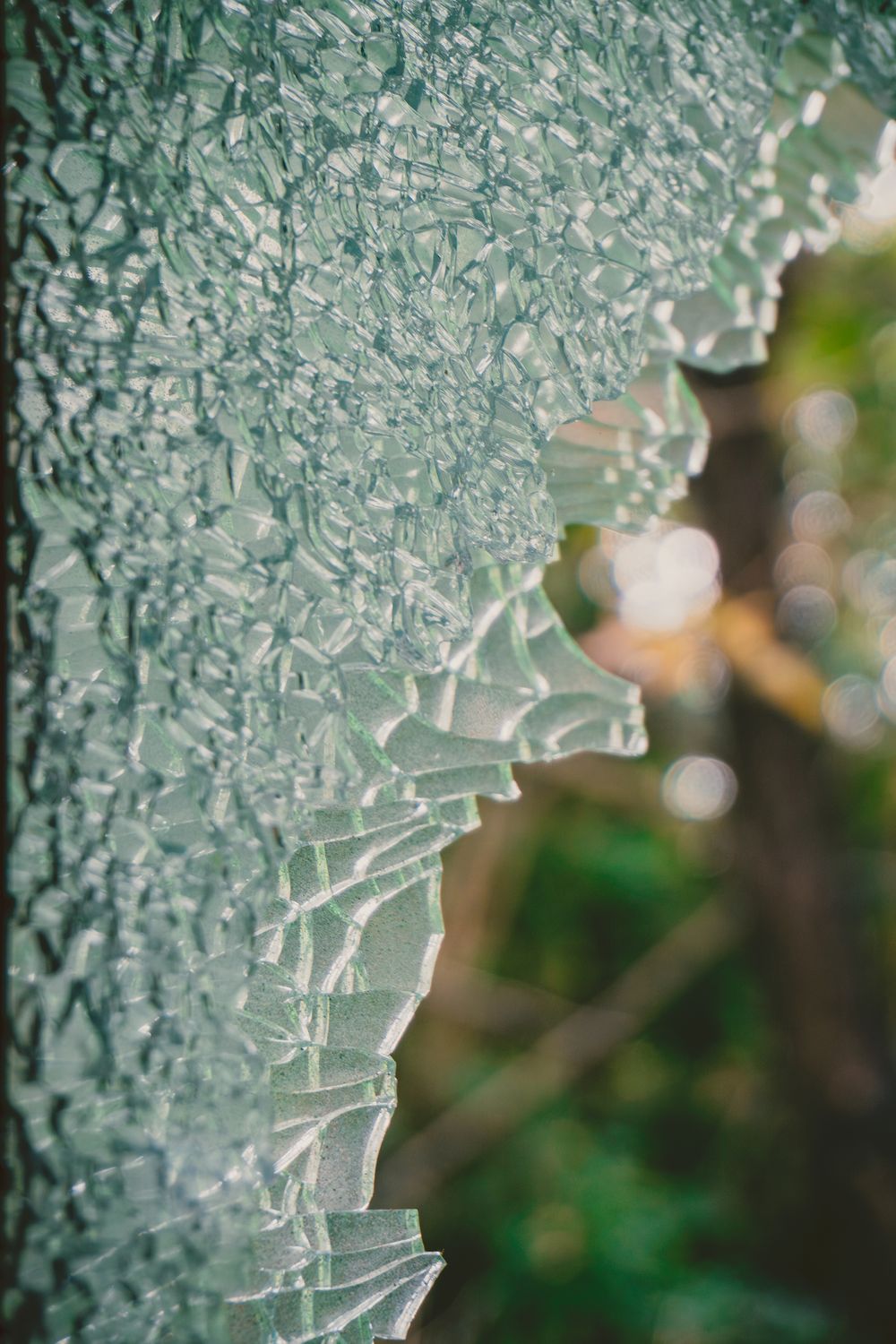 Close-up of Shattered Glass with Nature Background · Free Stock Photo