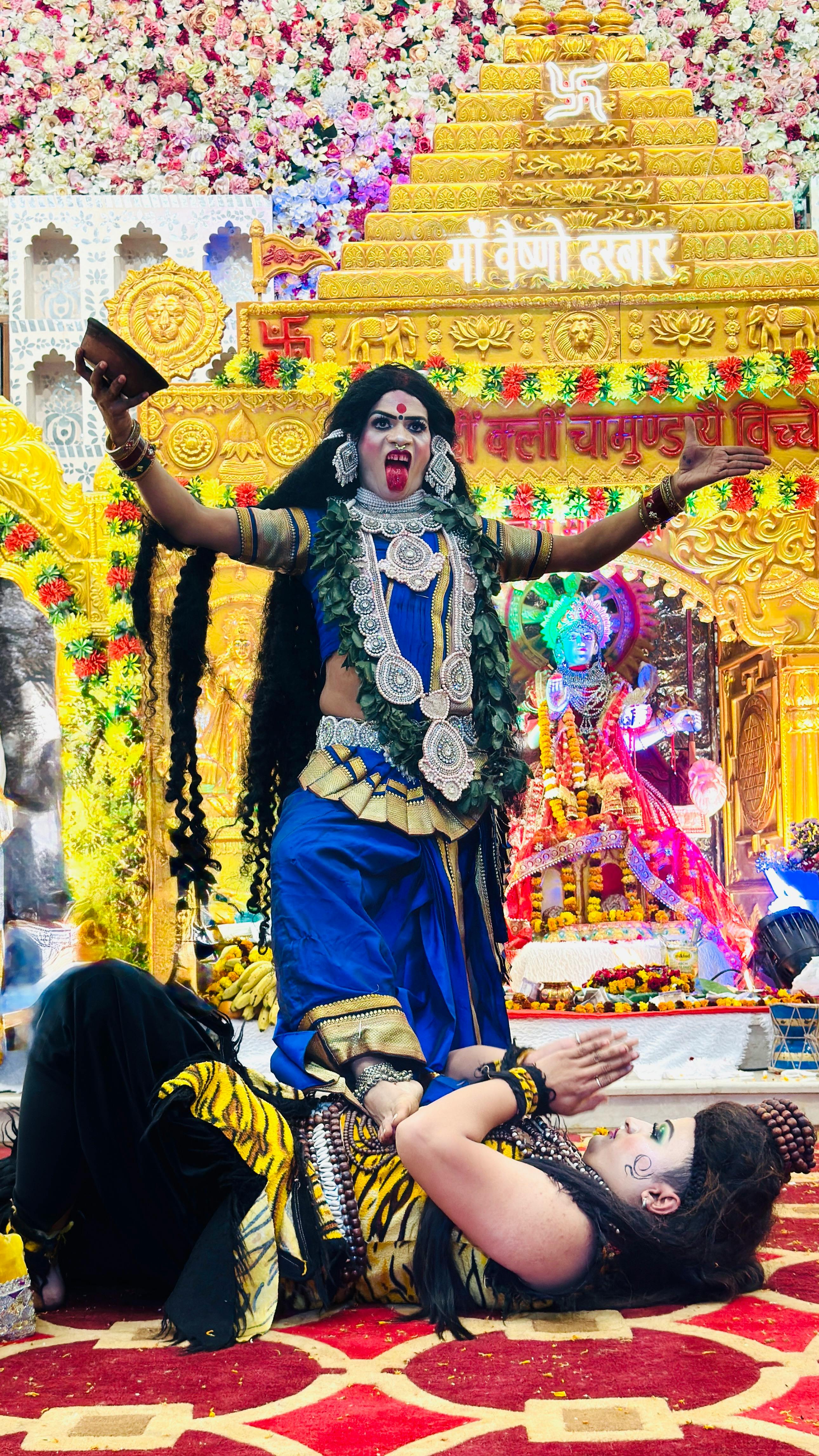 Colorful depiction of Hindu deities at a festival in Gurugram, India with traditional costumes.