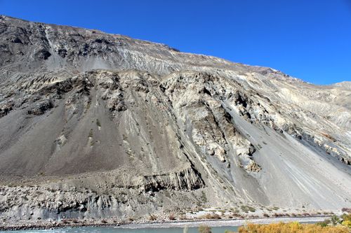 Free Breathtaking view of a rugged mountain range with clear blue skies highlighting its massive features. Stock Photo
