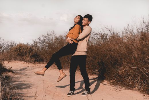 Photo Of Man Carrying Woman 