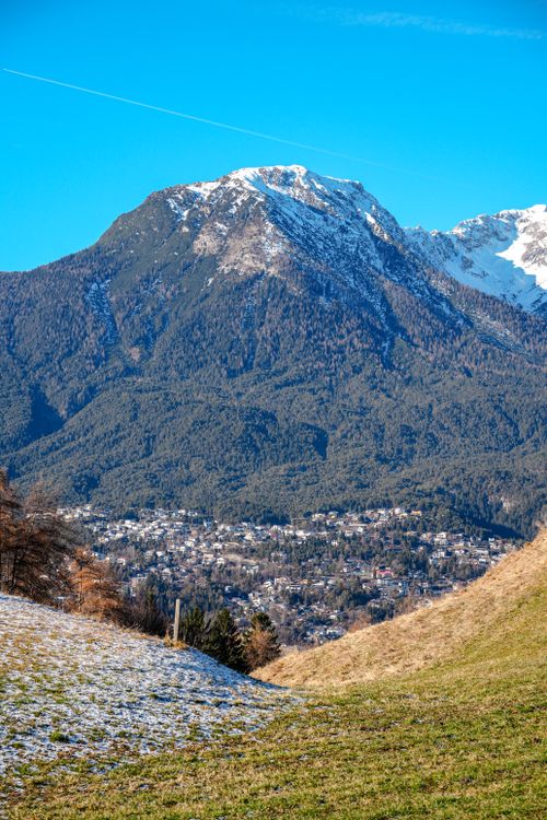 Free Breathtaking winter scene of snowy Tyrolean Alps with a small town below. Stock Photo