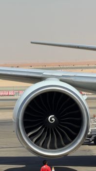 Detailed view of a large aircraft jet engine on an airport runway.