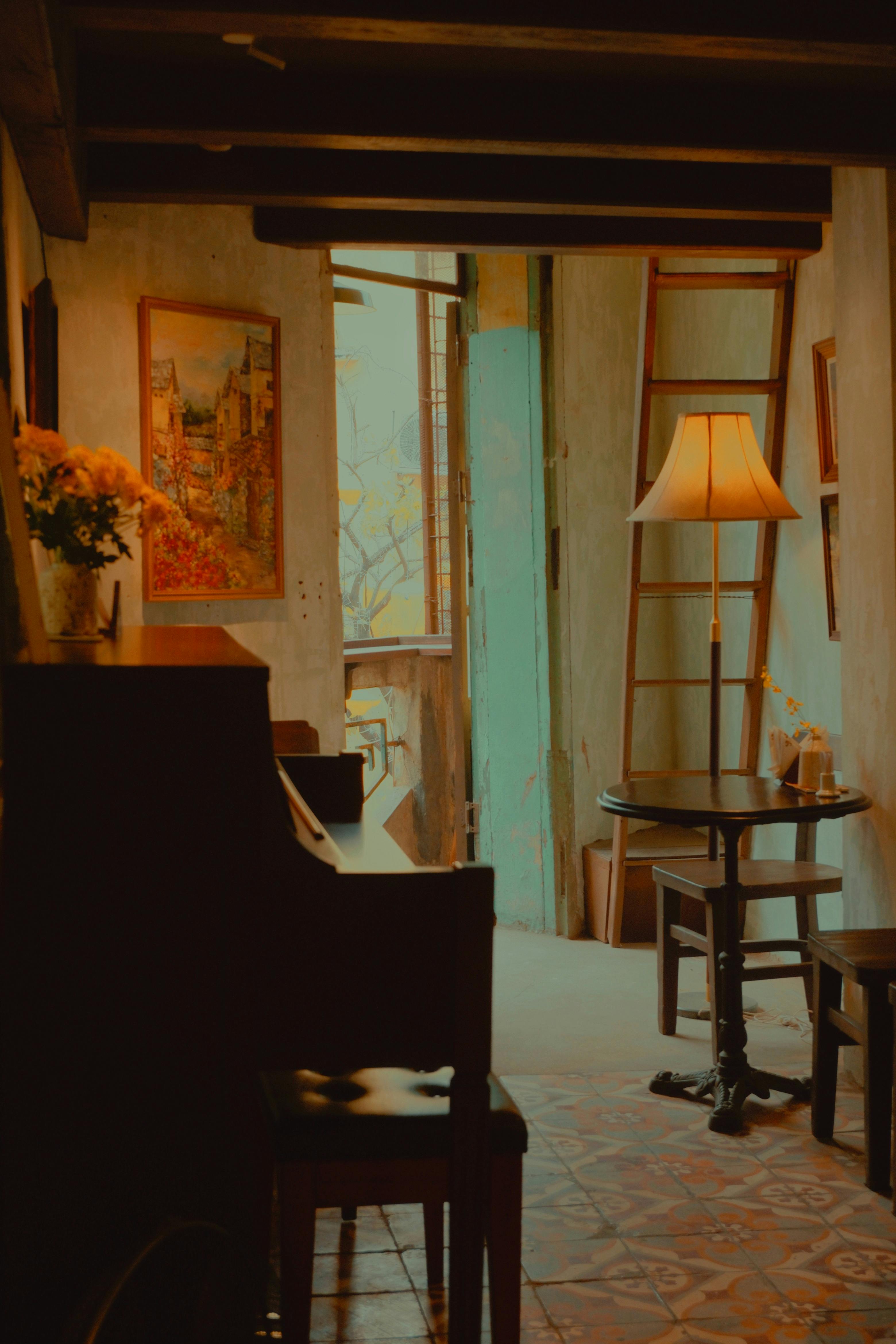 A cozy café in Hanoi with a warm, inviting atmosphere featuring a piano and ambient lighting.