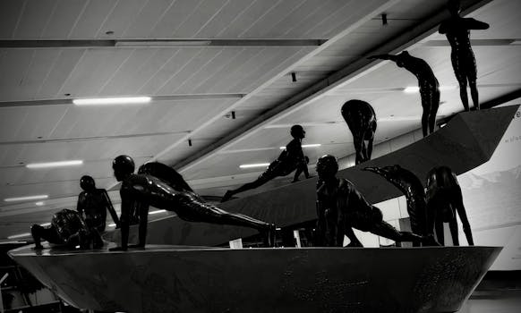 Black and white image of sculptures depicting human forms at Delhi airport indoors.