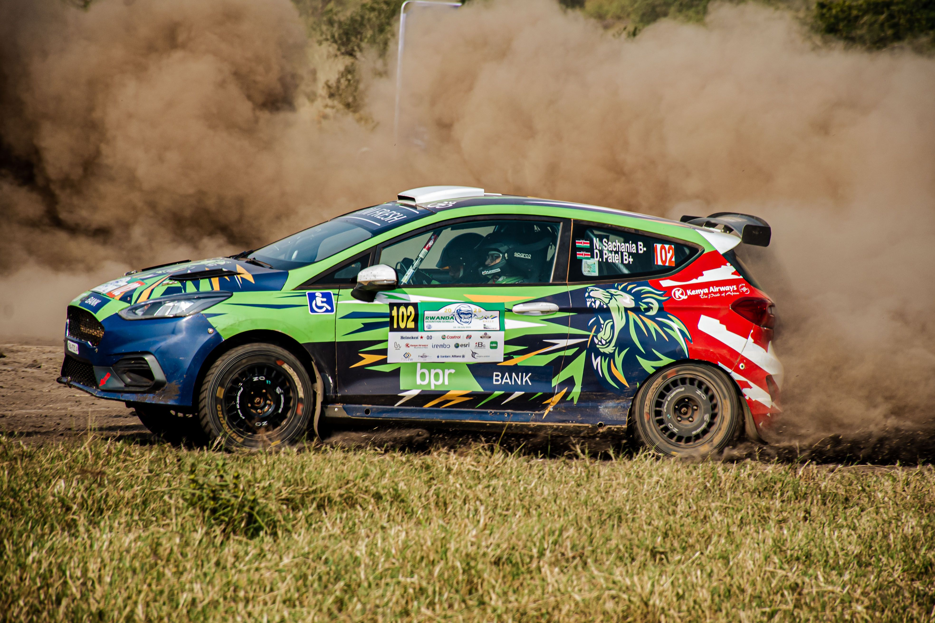 Dynamic Rally Car Racing on Muddy Terrain · Free Stock Photo