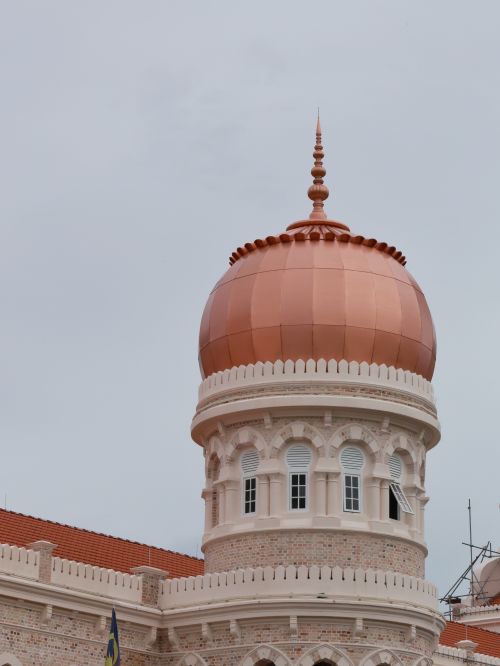 Free Close-up of a historical building's dome with intricate design and cloudy sky backdrop. Stock Photo