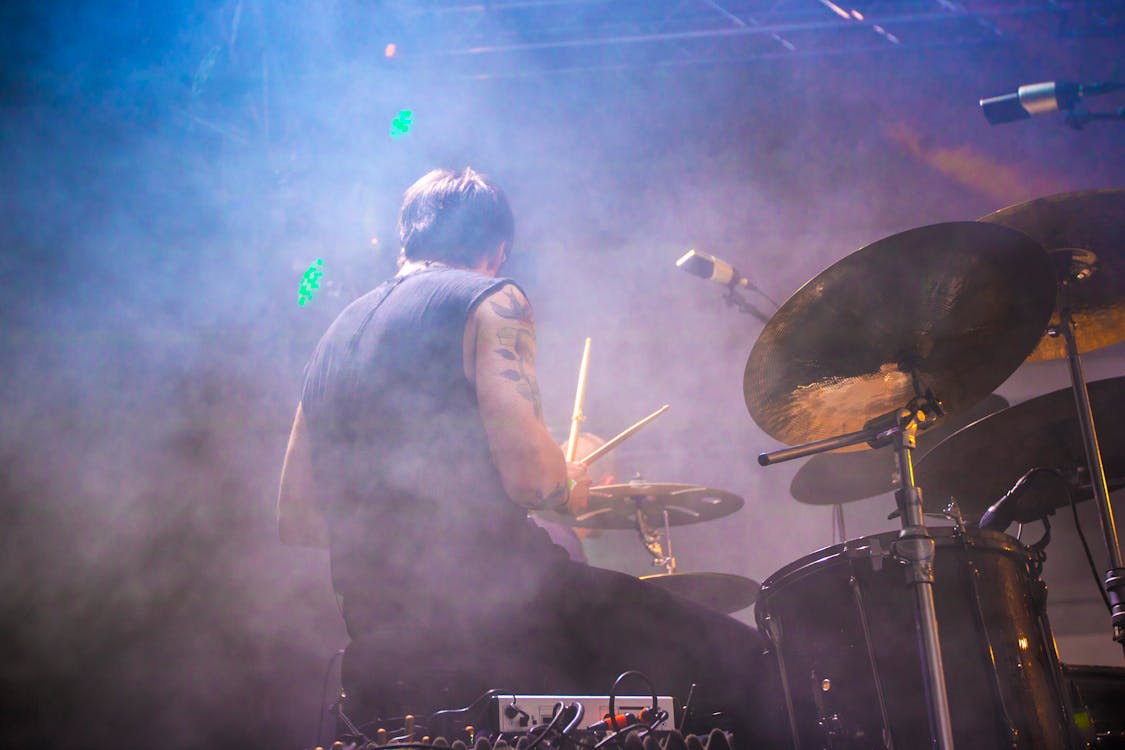 Free Performing Drummer Surrounded by Fogs Stock Photo