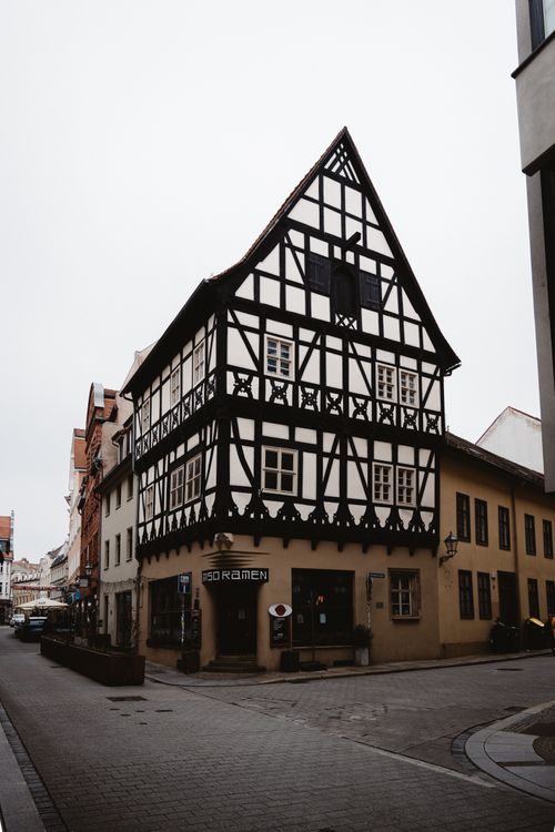 Free Charming half-timbered building in city street surrounded by classic architecture. Stock Photo