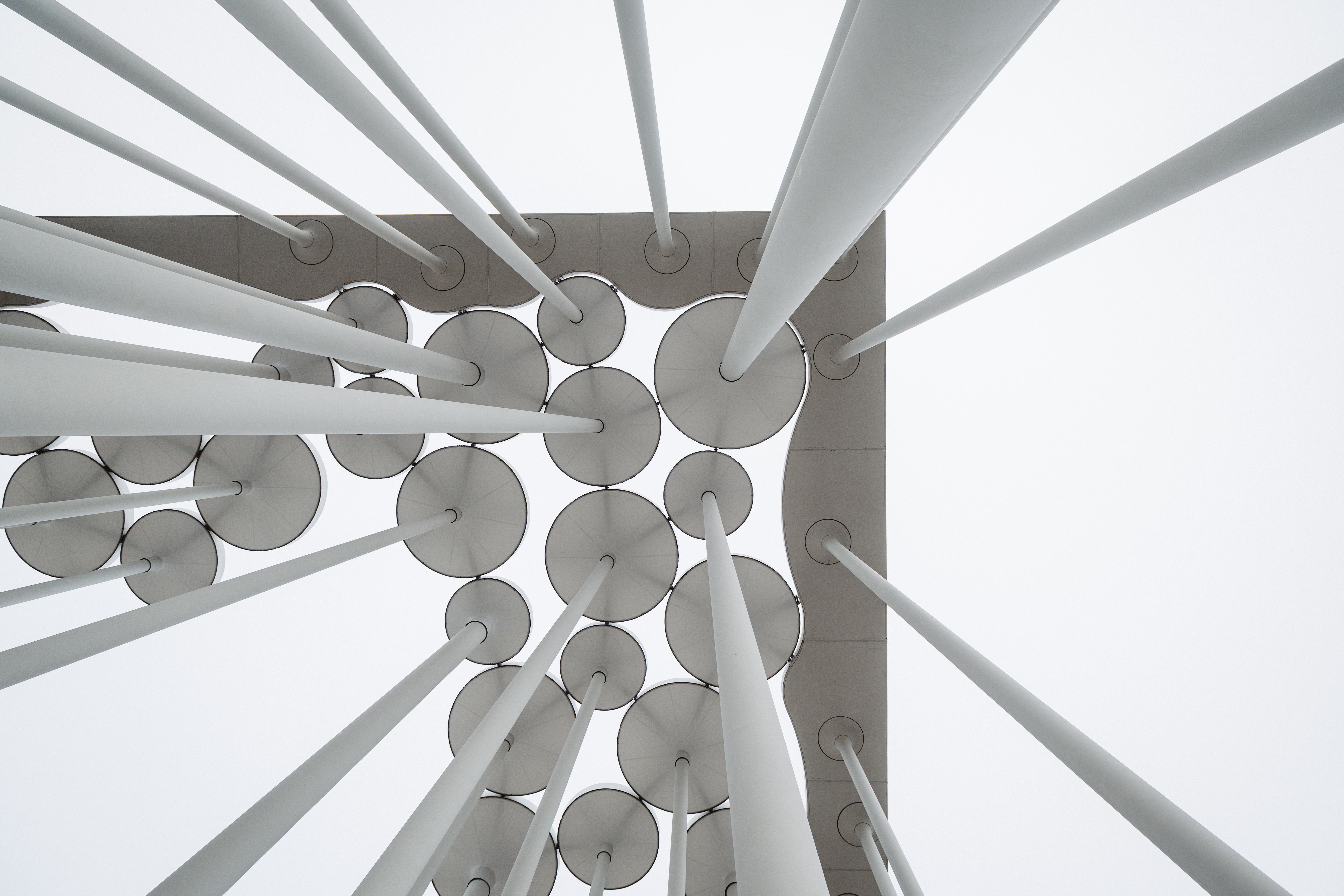 Free Stunning view of geometric architectural design with circular patterns, shot from below. Stock Photo