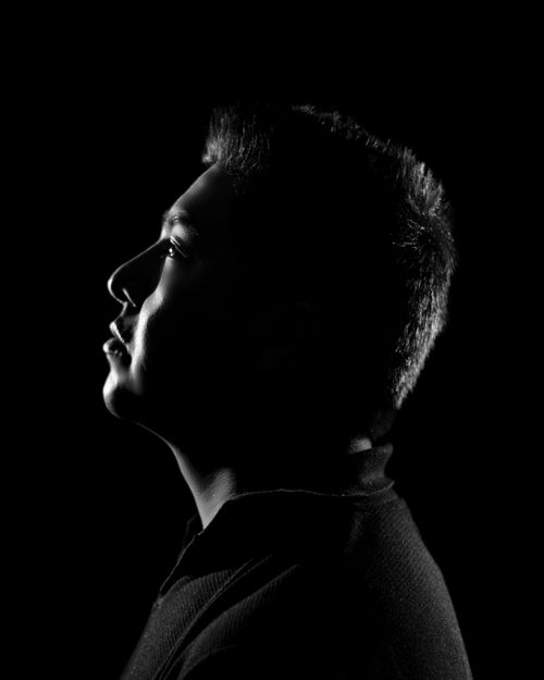 Free Intense black and white portrait of a man in profile, highlighting deep shadow contrasts. Stock Photo