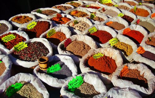Free Colorful array of spices in labeled bags at an outdoor market. Stock Photo