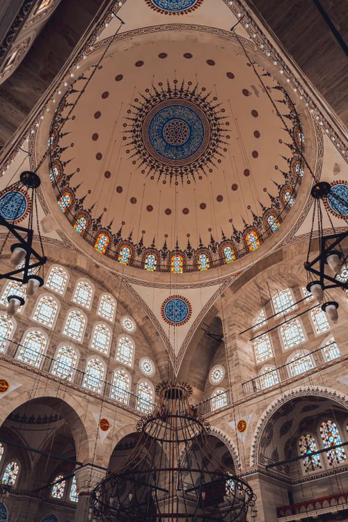 Free An ornate view of a historic mosque's dome with intricate patterns and lighting. Stock Photo