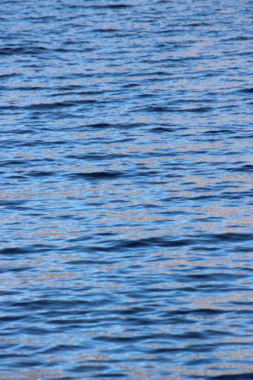 Free Calm blue water ripples on the surface of Lake Como under natural daylight. Stock Photo
