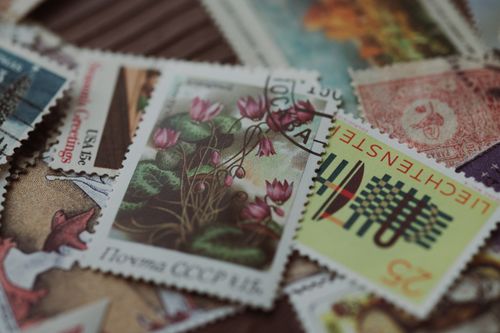 Free Close-up image of a collection of vintage postage stamps showcasing diverse designs and colors. Stock Photo