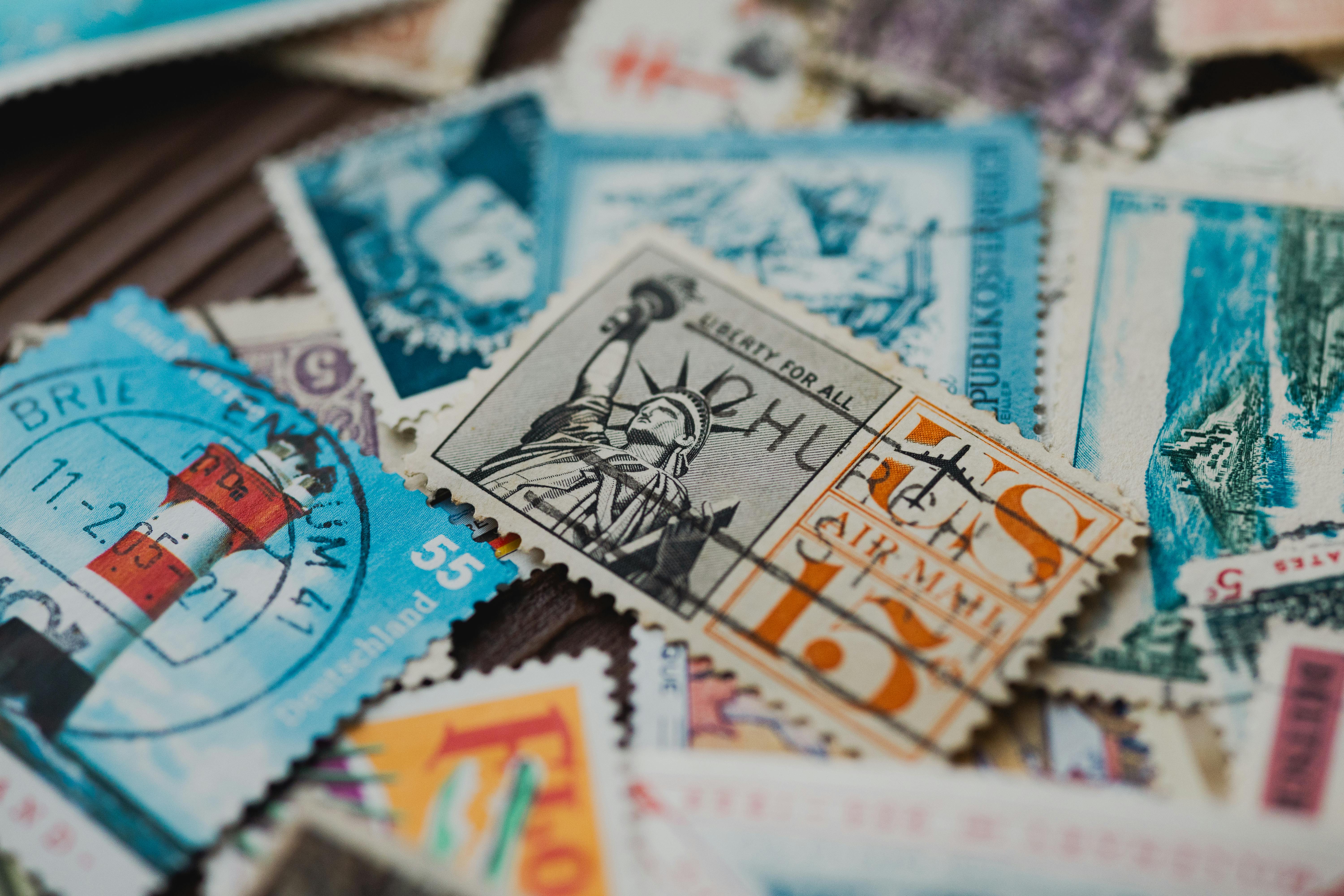 A detailed shot of various vintage postage stamps featuring iconic landmarks and designs.