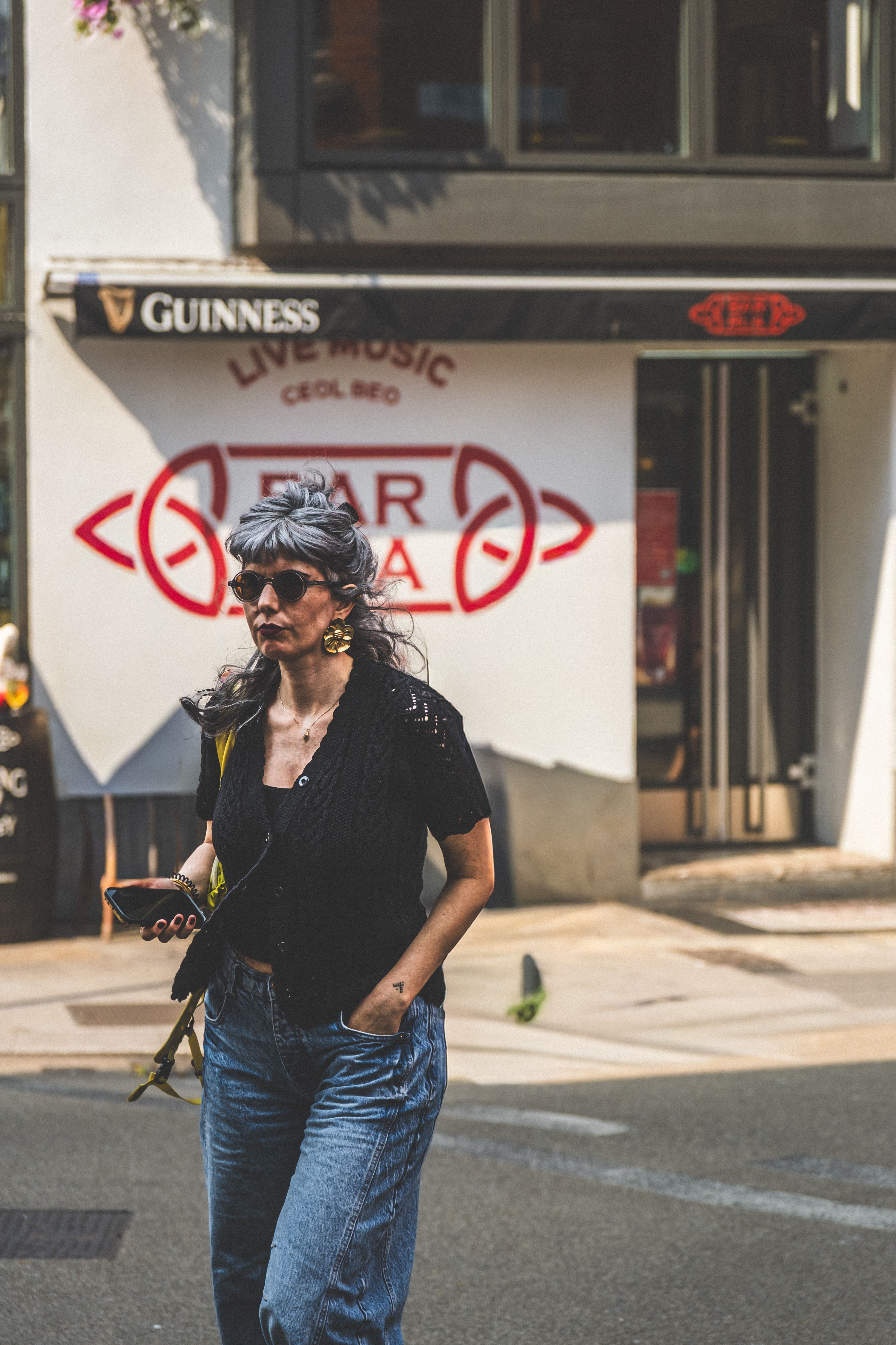 Stylish Woman Walking on Lively City Street · Free Stock Photo
