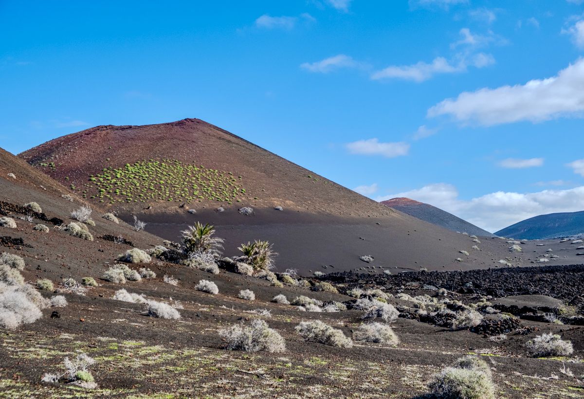 Teren vulcanic pustiu din Timanfaya, Lanzarote, sub un cer albastru intens