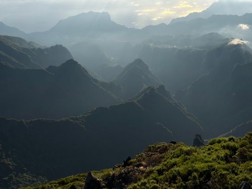 Free Dramatic view of foggy mountains with sunlight streaming through clouds. Stock Photo