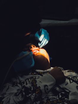 A dentist performs an examination on a patient in Mathura, India.