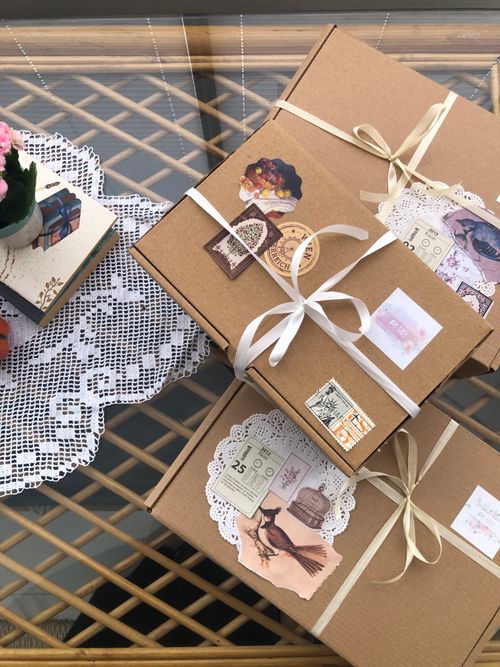 Free Charming gift boxes with vintage embellishments and lace on a decorative table. Stock Photo
