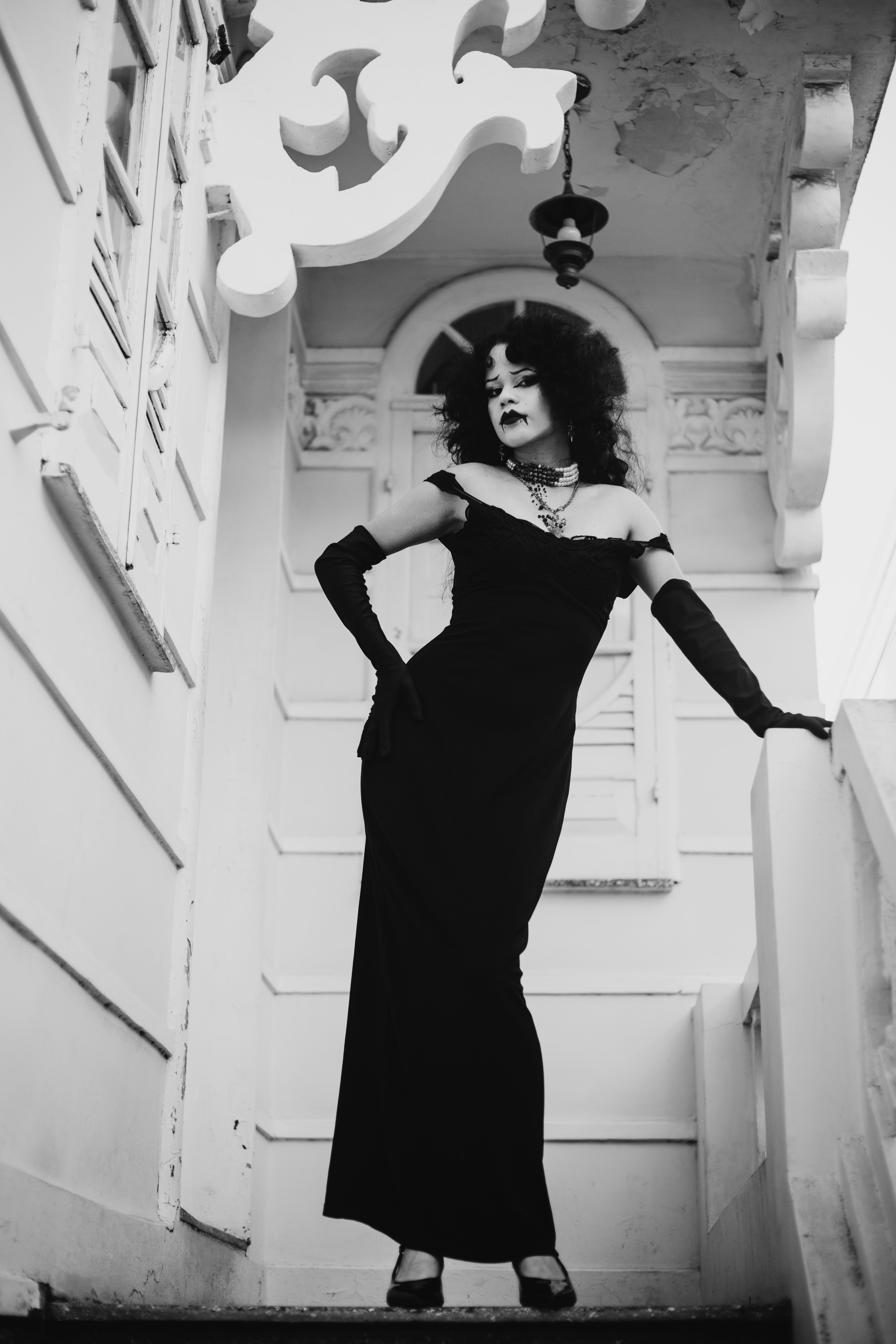 Elegant Woman in Black Dress on Vintage Stairs  Free Stock Photo