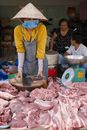 Woman wearing Conical Hat Selling Raw Meat