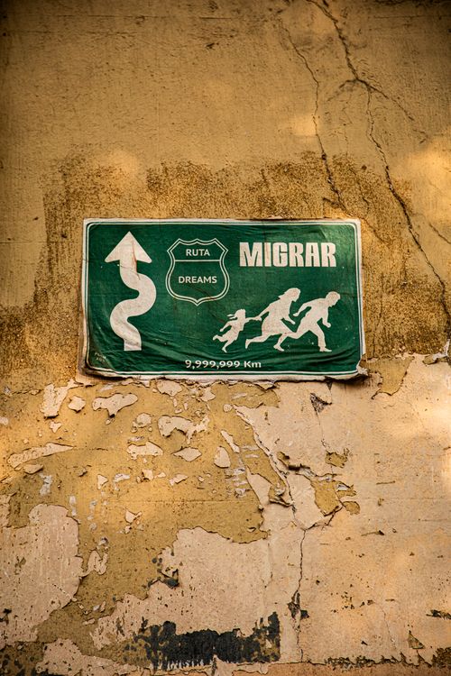 Street Sign with Migration Theme Art · Free Stock Photo